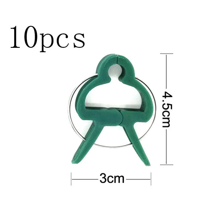 Green plastic and zinc plant fixing clips for supporting tomato vines and climbing plants in the garden.