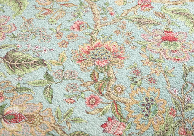 Blue American floral quilted cotton bedspread set on a bed, showing the three-piece 230x250 cm cover.