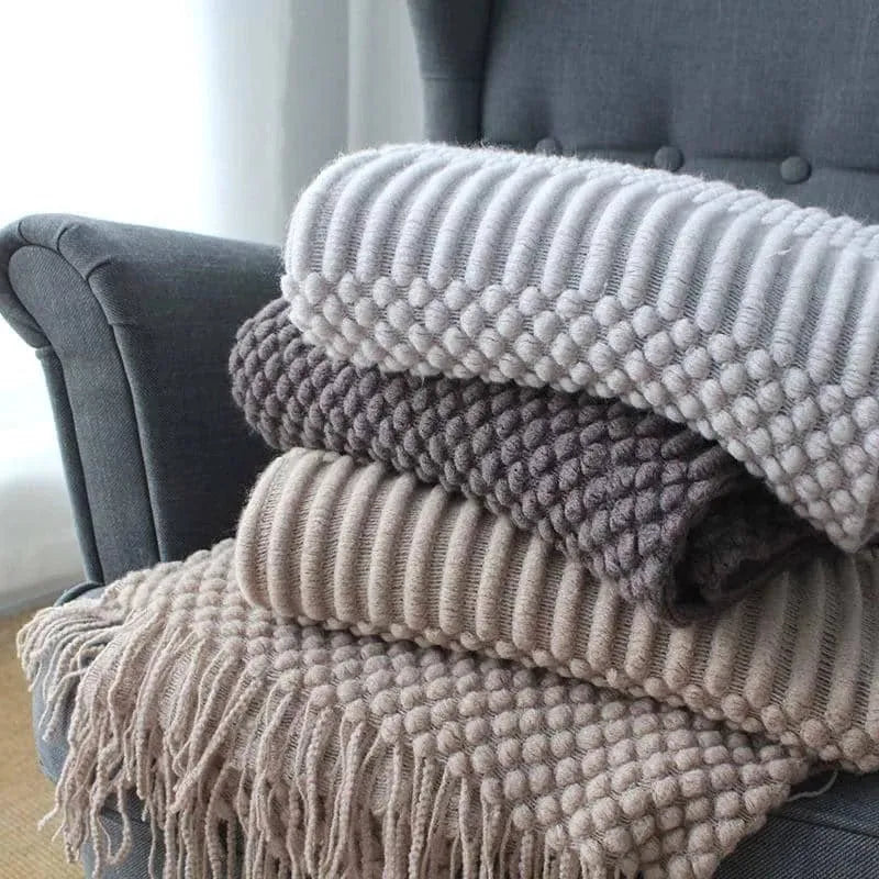 Small polyester blanket in dark grey, khaki or light grey colours measuring 127 by 170 centimetres
