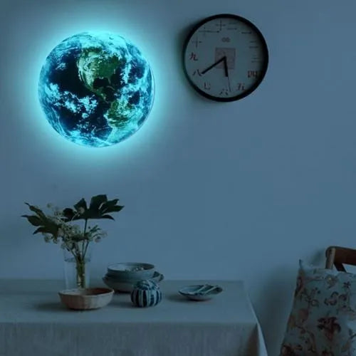 Glow in the dark 3D planet Earth wall sticker on a dark blue background, showing its luminous effect.
