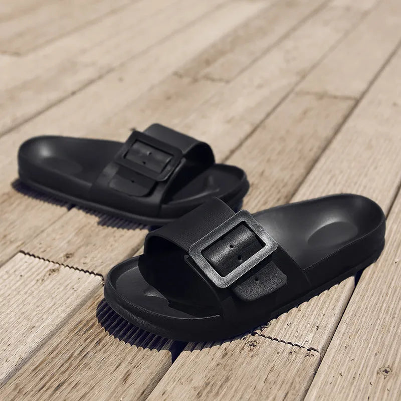 Women's grey blue buckle flip flops with a soft EVA sole on a plain background