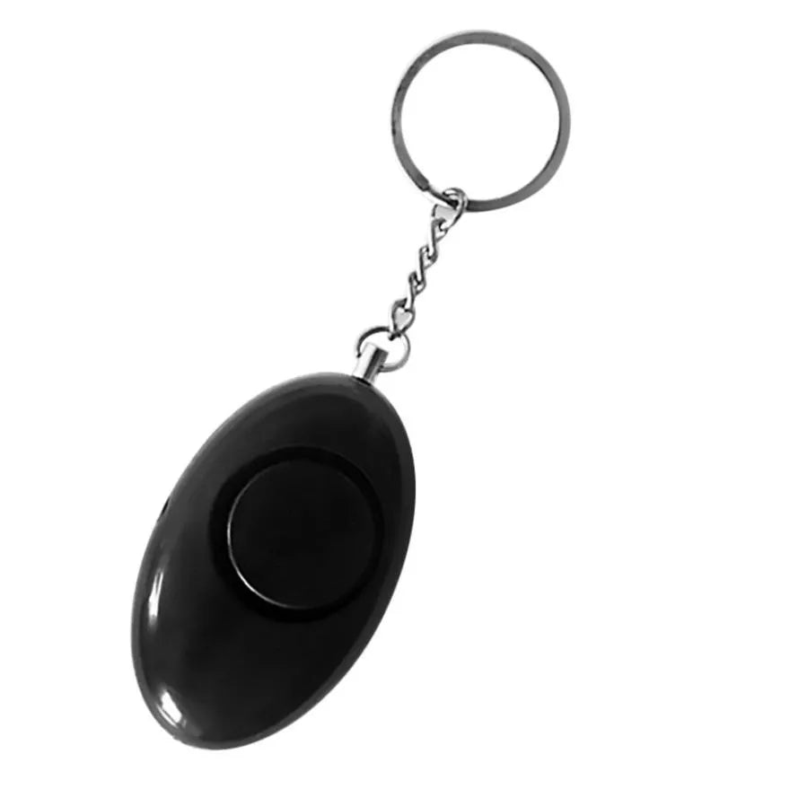 Egg-shaped personal safety alarm keychain in pink with metal pin on a white background