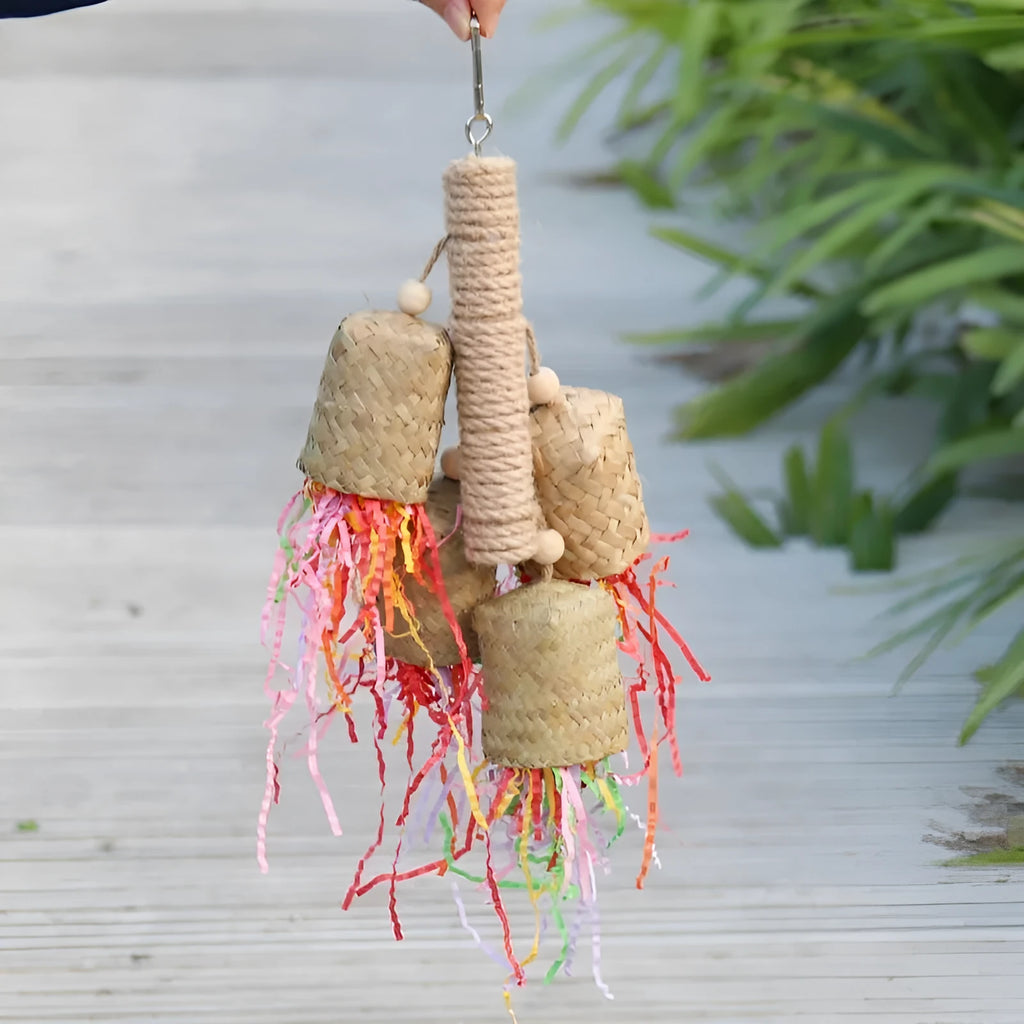 Colourful parrot chew toy with wood base, sisal rope and blue shredded paper attachments