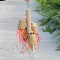 Colourful parrot chew toy with wood base, sisal rope and blue shredded paper attachments