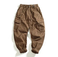 Men's multi-pocket stretch cargo casual pants in khaki, mid-waist ankle-tied style, worn-looking woven fabric