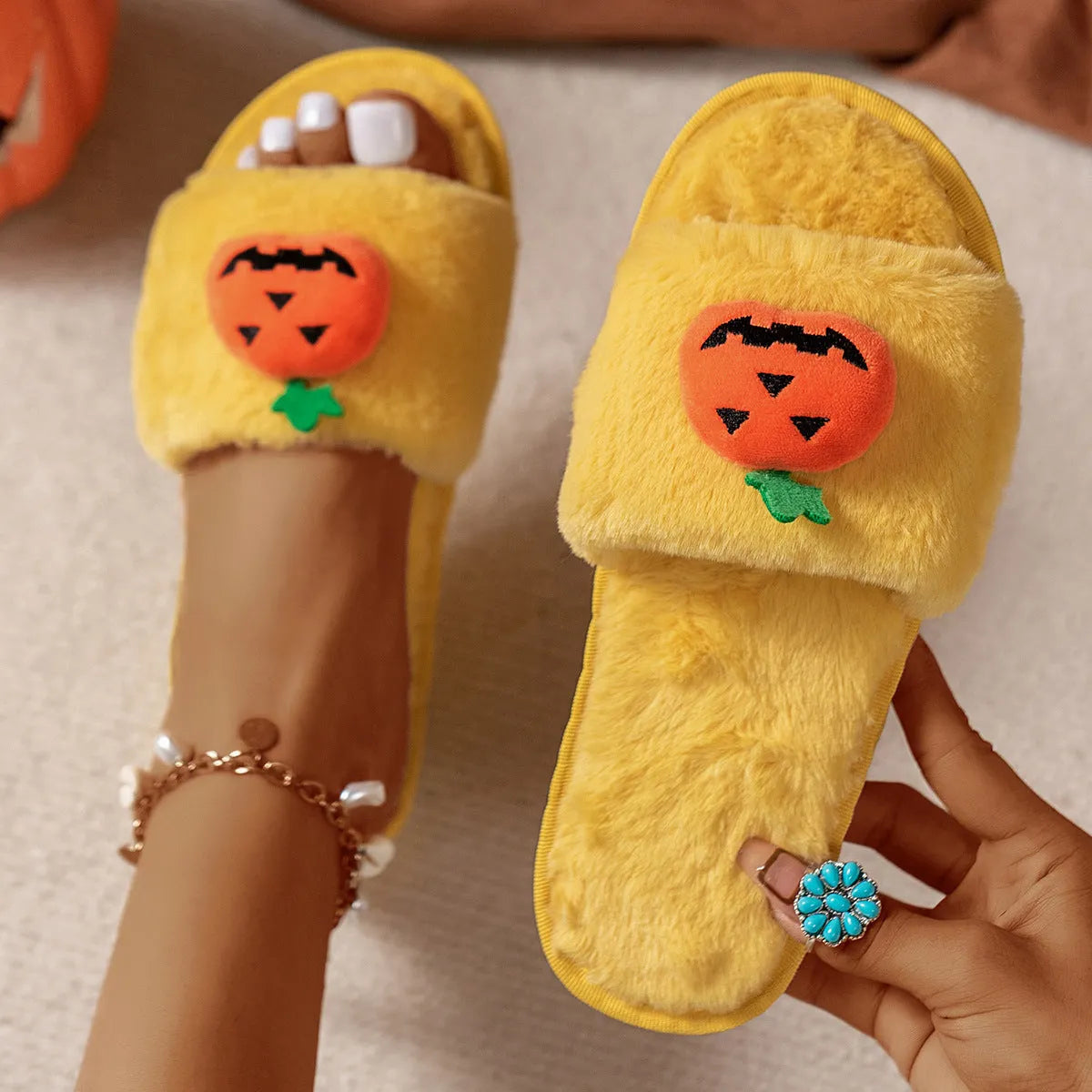 Yellow pumpkin cartoon design open-toe slippers with plush synthetic fur upper.