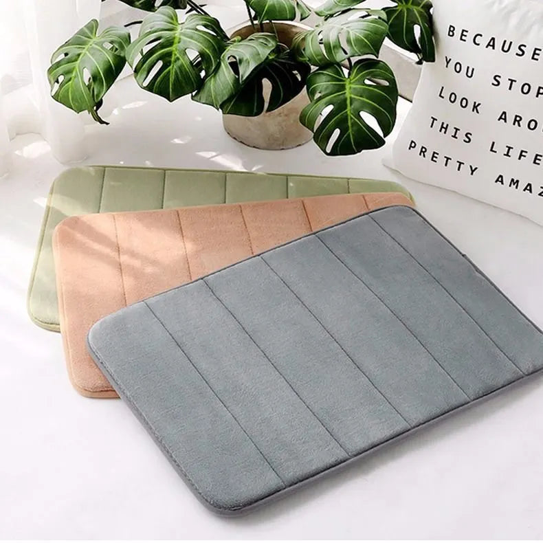 Coral fleece non-slip bath mat in 40x60cm size, placed on bathroom floor with water absorbent surface