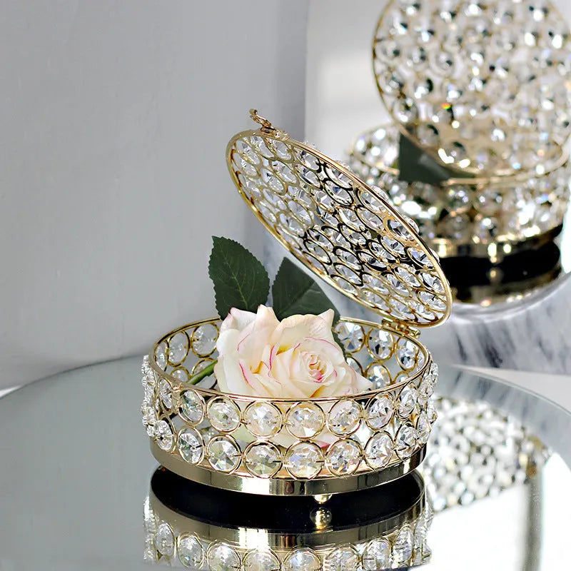 French gold iron frame crystal glass jewellery box with a metal lock closed.
