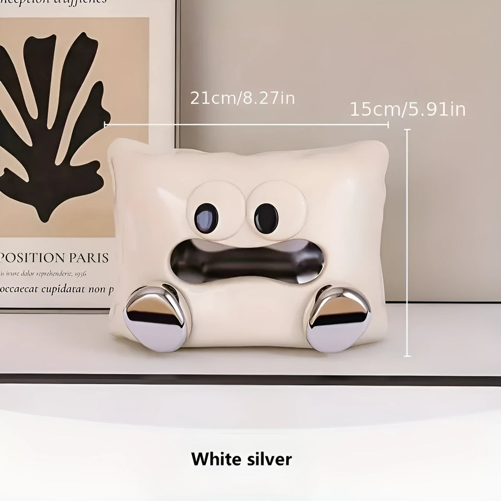 White ceramic square tissue box holder with polished glazed finish on a living room coffee table