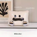 White ceramic square tissue box holder with polished glazed finish on a living room coffee table
