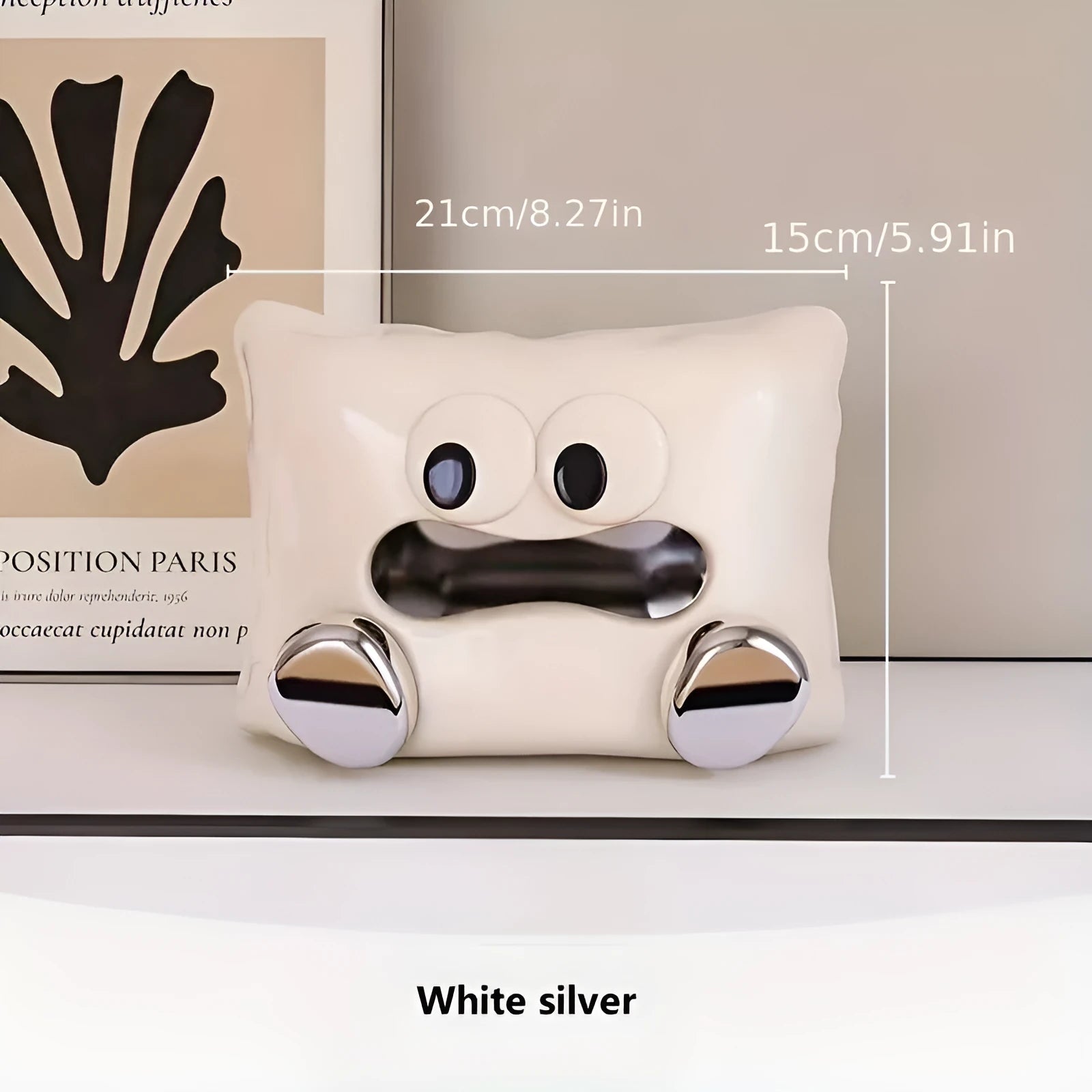 White ceramic square tissue box holder with polished glazed finish on a living room coffee table