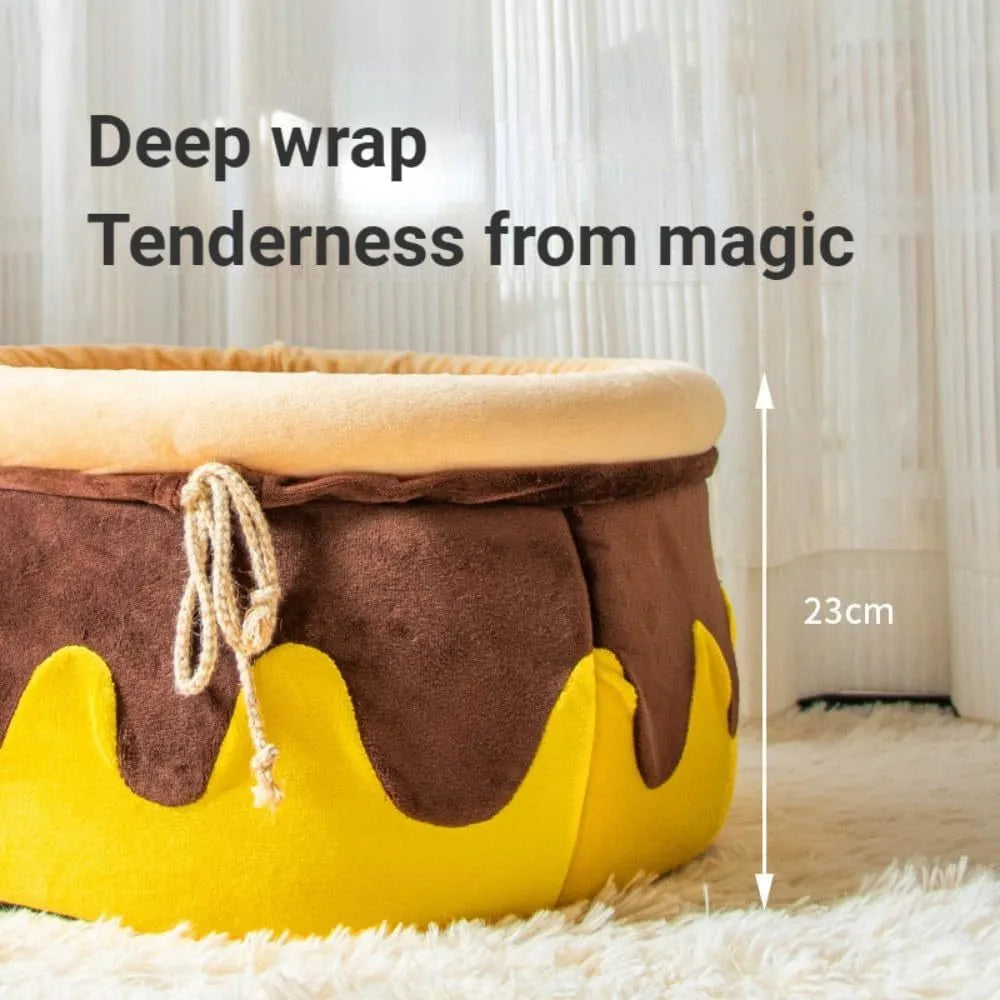 Pink honey pot-shaped cat bed with magic wand design and a soft, removable inner cushion.