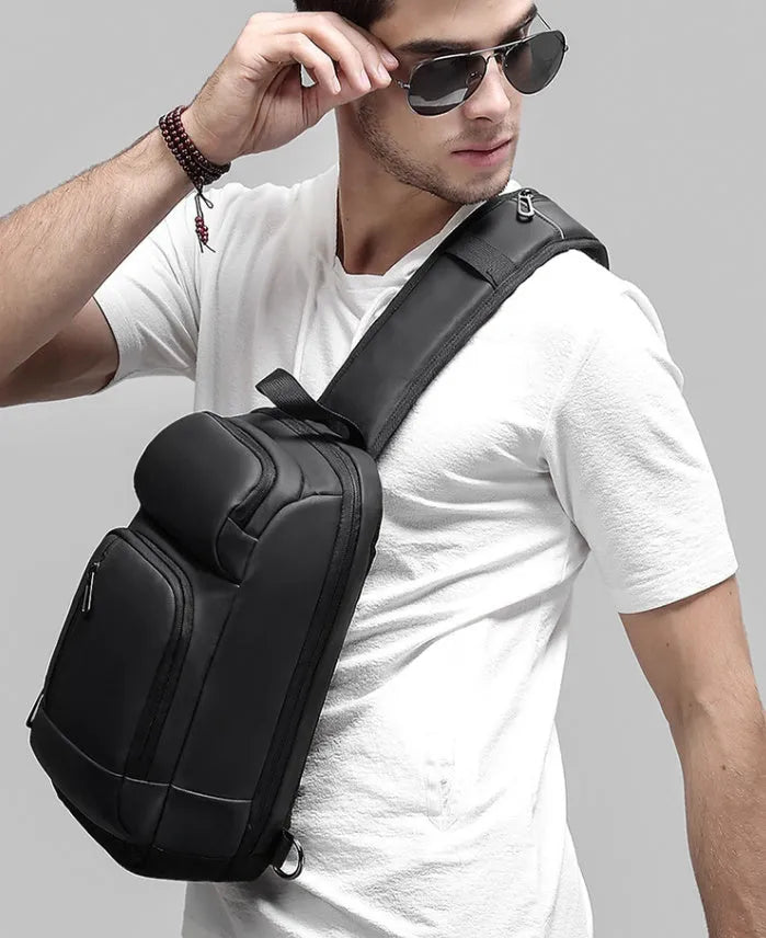 Black PVC outdoor leisure shoulder bag showing air cushion strap and organisational pockets