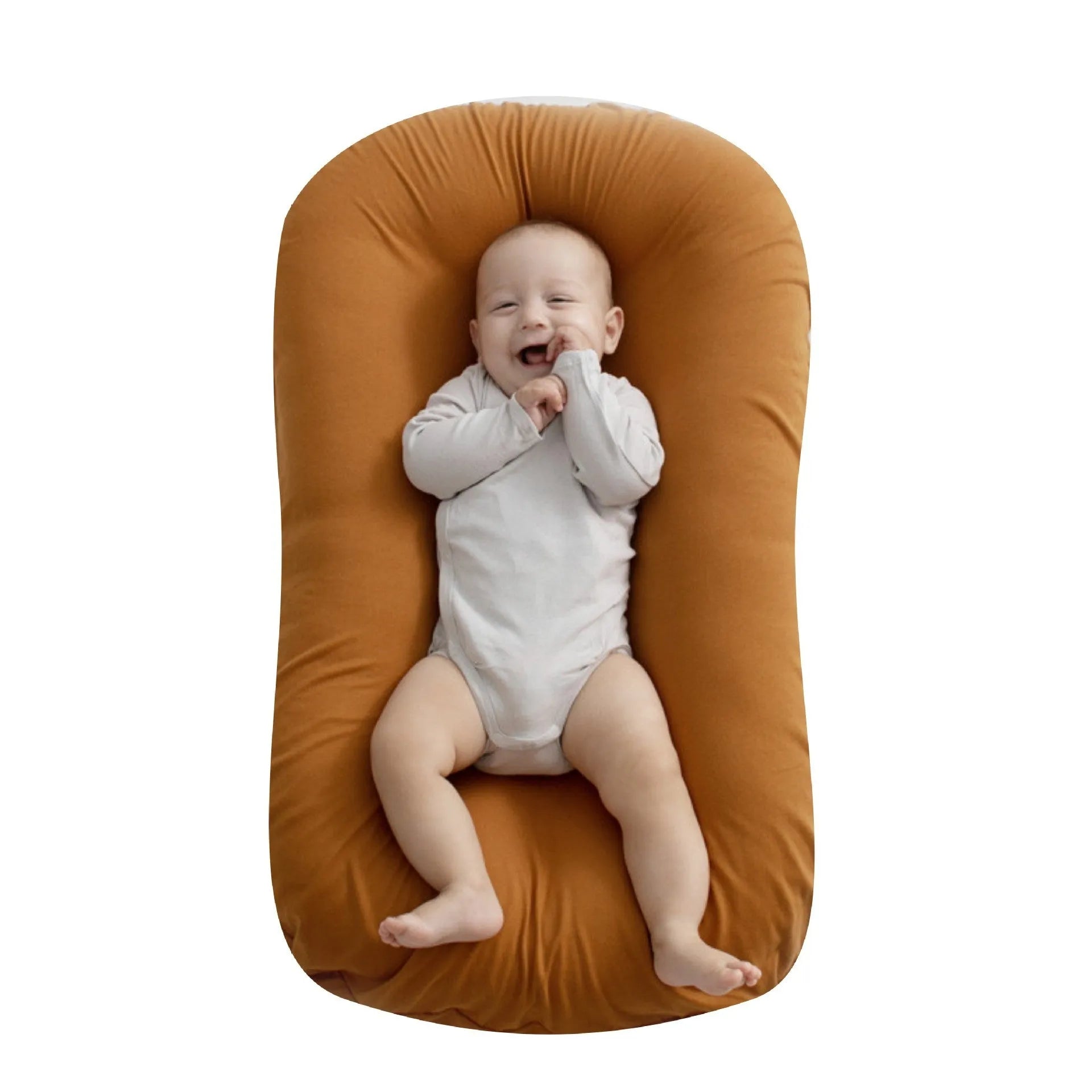 Beige portable baby nest crib for newborns measuring 75cm by 45cm on a neutral background.