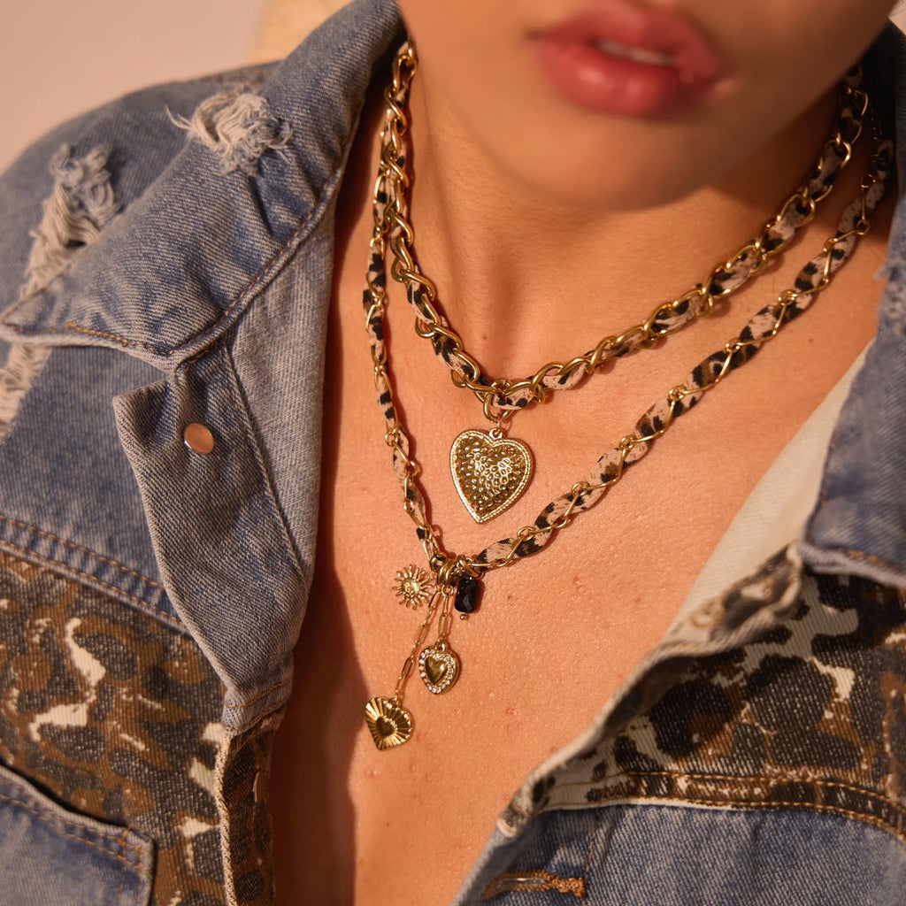 Leopard Love stainless steel necklace with 18K gold plating, showing geometric Big Heart or Love Sun pendant on an adjustable chain.