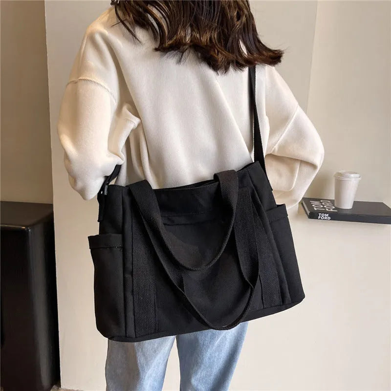 Women's polyester canvas shoulder bag with sandwich pocket in black, white, brown, or green
