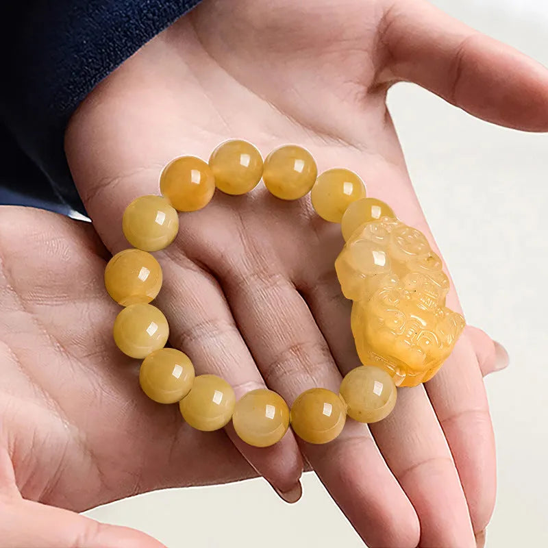 Personalised carved Golden Thread Jade bracelet showing bead detail and size comparison.