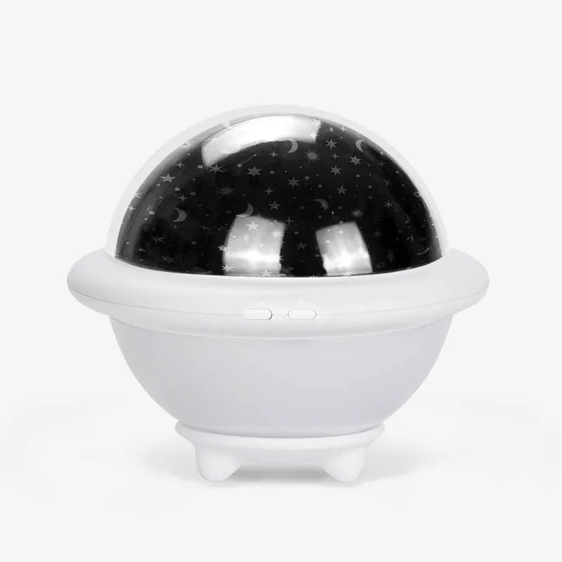 Green UFO shaped LED night light projecting starry sky pattern on ceiling