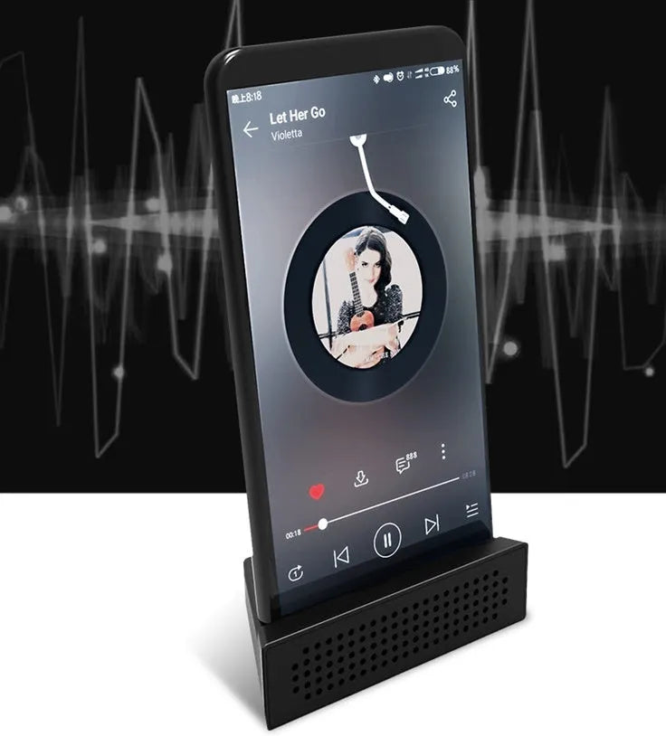A portable black ABS plastic mobile phone amplifier bracket holding an iPhone.