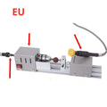 Mini metal woodworking lathe with silver finish and carving accessories on workbench