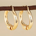 Geometric copper women's earrings with ring and line elements in golden colour