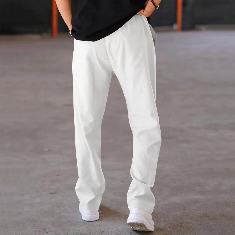 Men's loose straight drawstring trousers in waffle polyester fabric, shown in multiple colour options