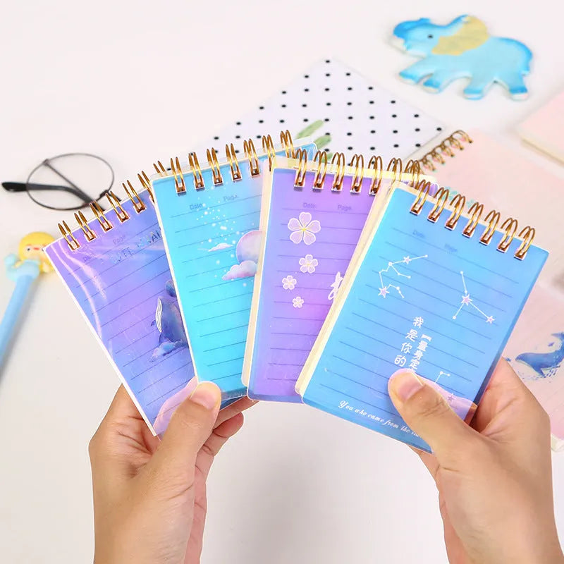 A7 spiral-bound notebook with a PP plastic cover in one of four colour options, showing the spiral binding and compact size.