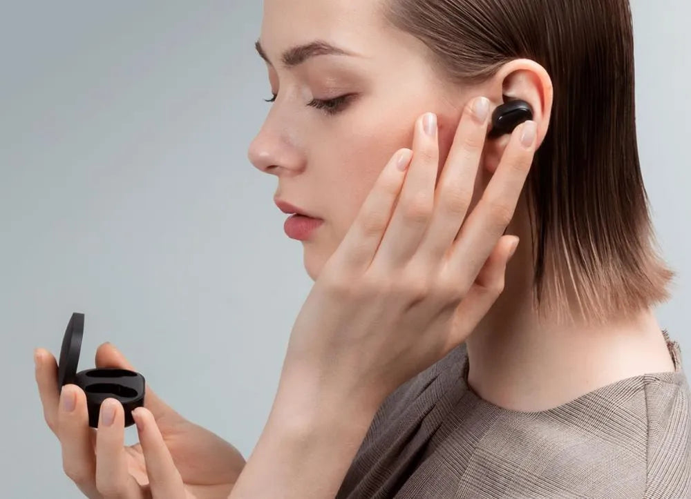 Redmi AirDots Black true wireless earbuds and charging case on a white background.