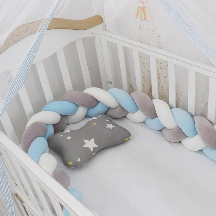 Multi-colour baby crib bumper made of spandex velvet, shown bent around a crib edge.