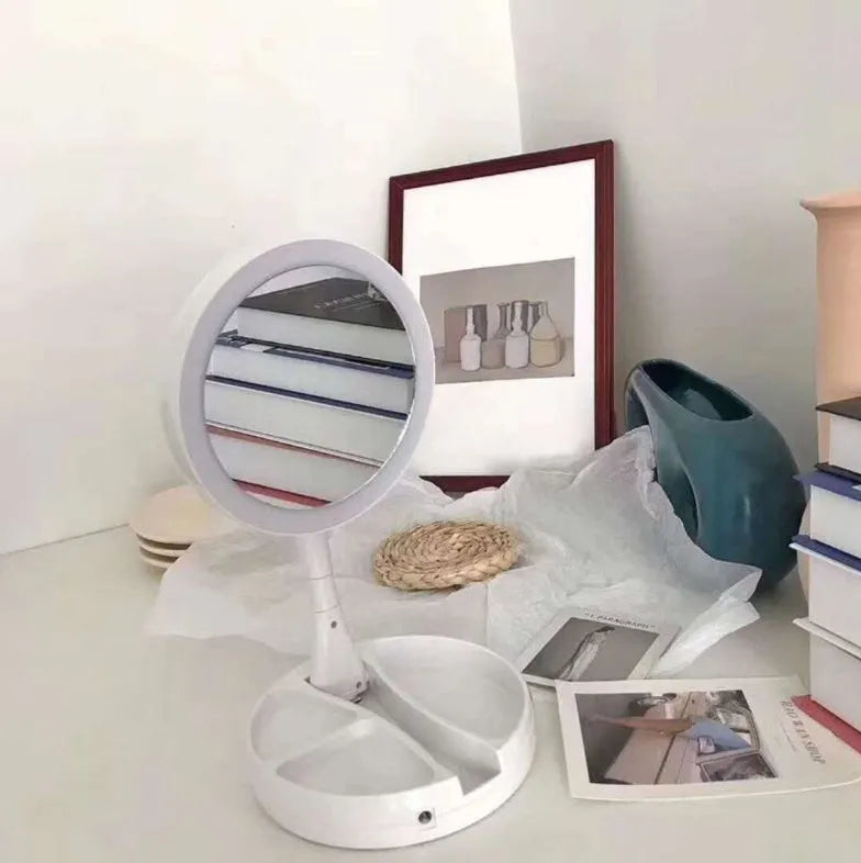 White foldable acrylic vanity mirror with LED lights and double-sided storage compartments