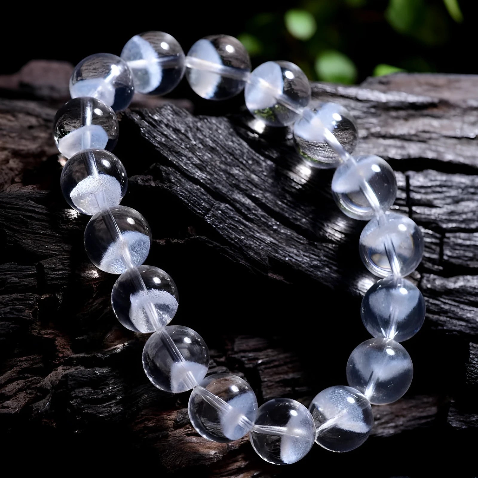 Women's white crystal bracelet with a ghost pyramid charm and Ruyi symbol, showing round beads.
