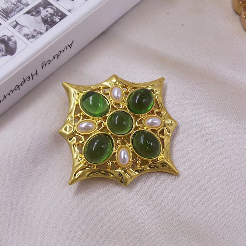 Close-up of a vintage medieval baroque cross brooch with crystals, made from zinc alloy.