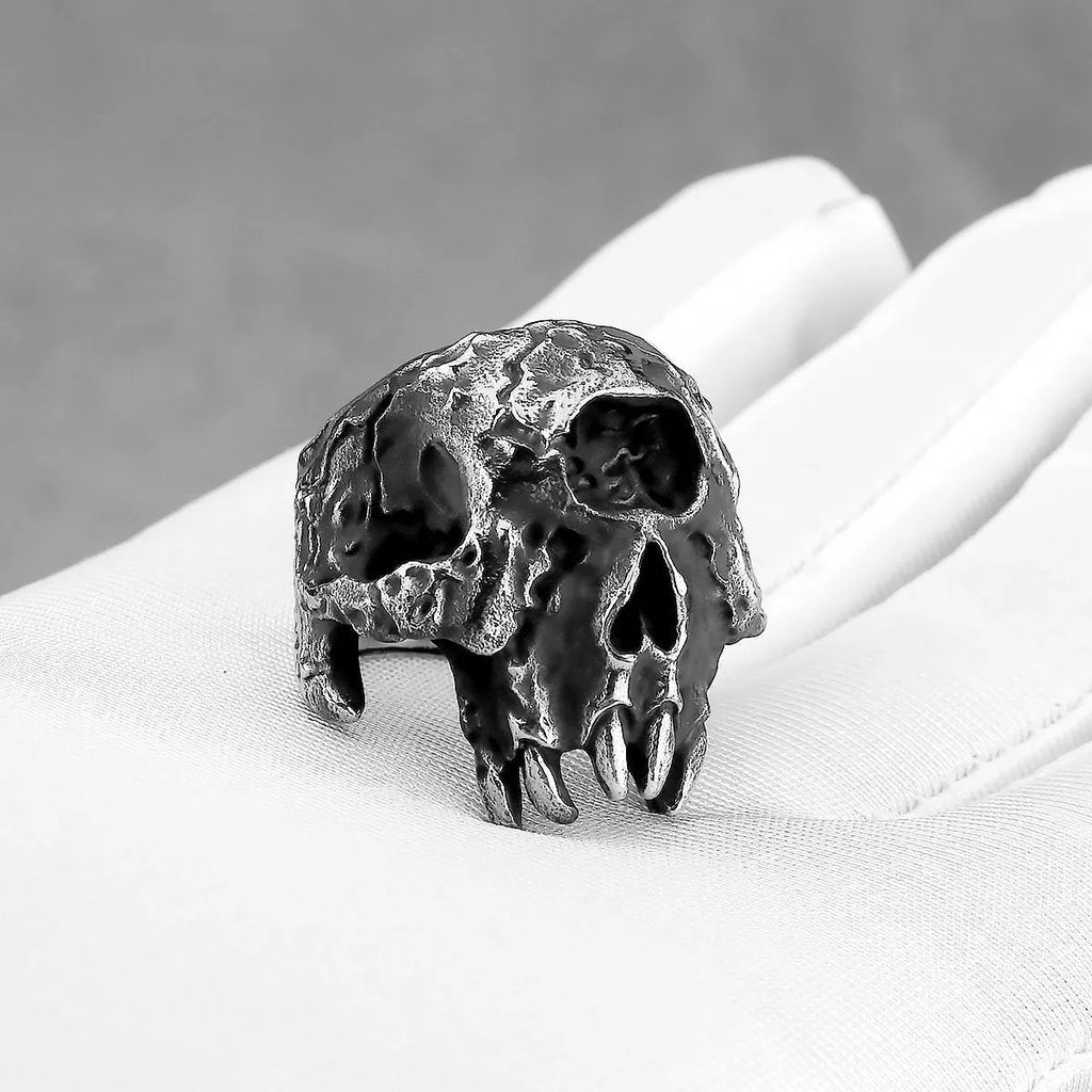 Alloy one-eyed skull ring in retro punk style on a black background.