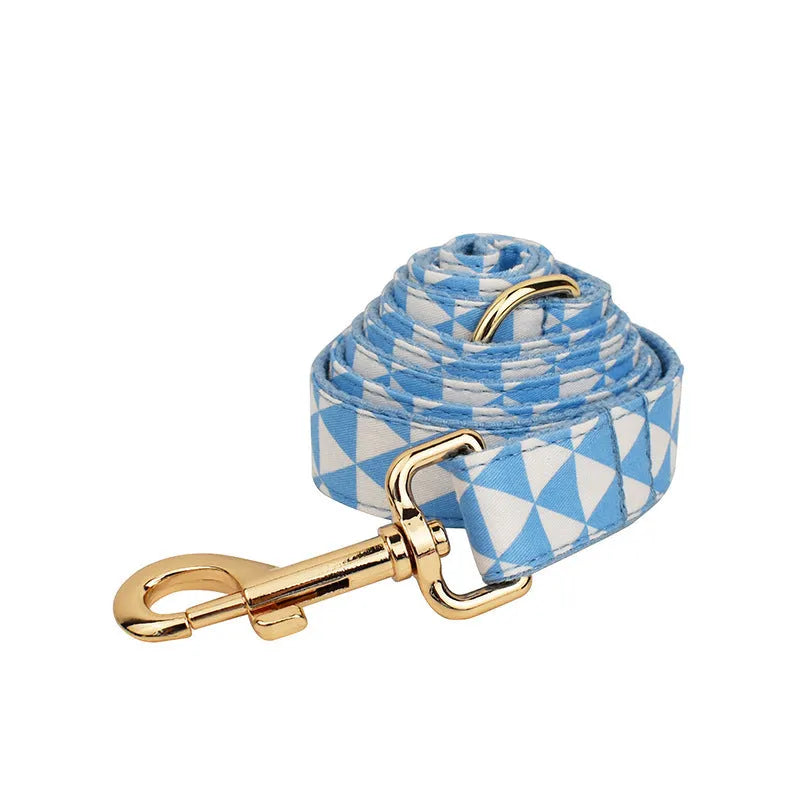 Blue cloth dog vest with triangular rope design, matching collar, leash and bow in a four-piece pet accessory set