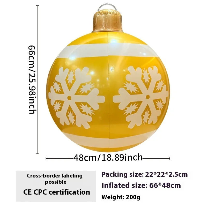 Large red and white inflatable Christmas ball with flashing lights in a garden setting.