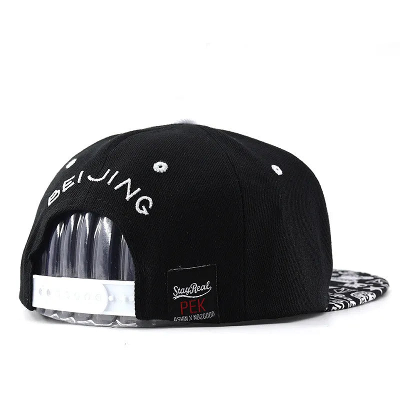 Cotton baseball cap with embroidered lettering in black or white with adjustable strap