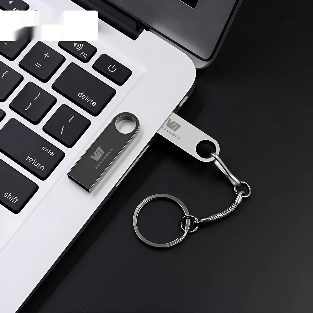Car-shaped metal USB flash drive in silver colour showing compact design and USB connector
