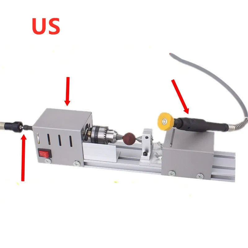 Mini metal woodworking lathe with silver finish and carving accessories on workbench