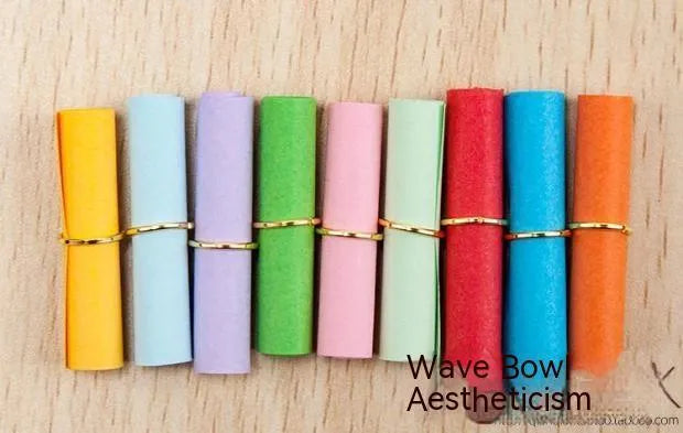 Multi-coloured mini paper scrolls in various sizes with metal eyelets for hanging.
