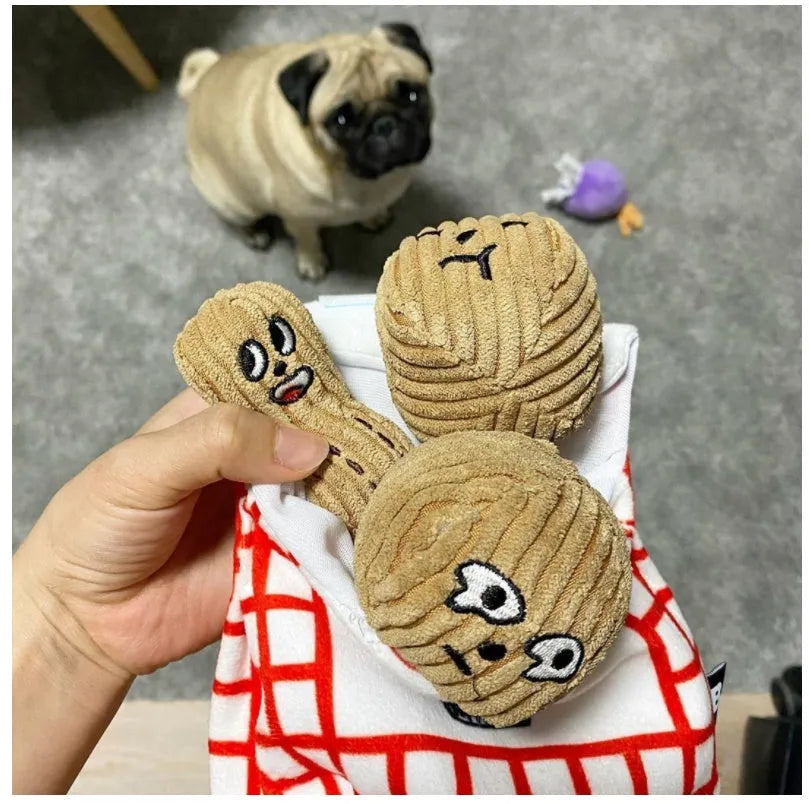 Hidden food toy set for dogs with two walnut toys, one peanut toy, and a rustling paper snack bag on a table