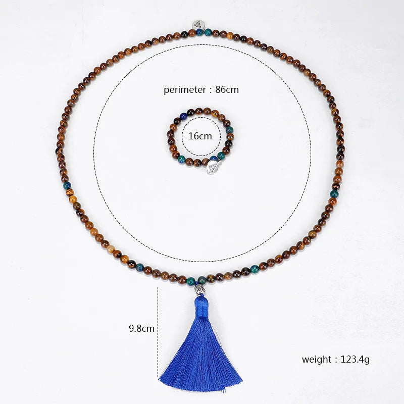 Handmade tiger eye stone bead necklace with tassel pendant and matching bracelet on a neutral background