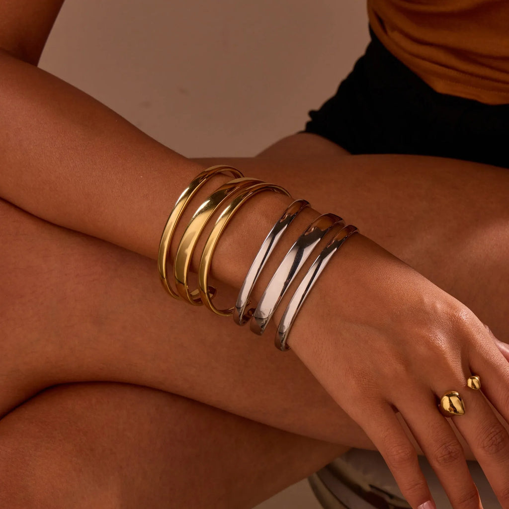 Geometric stainless steel women's bracelet with a simple opening, shown in gold and steel colour options.
