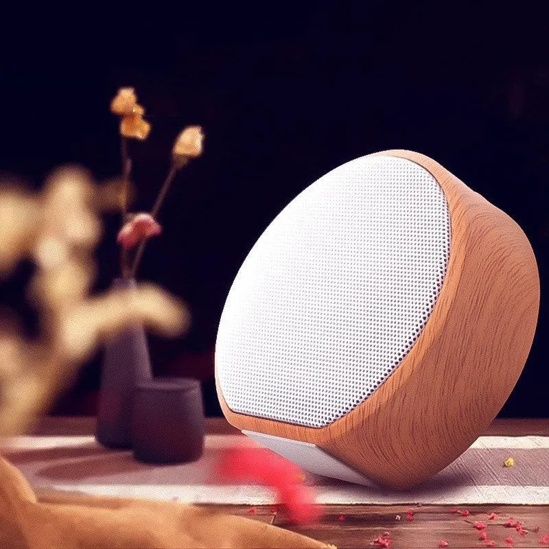 White wood grain Bluetooth speaker on a desk