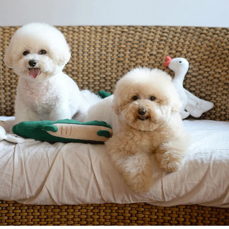 Green soft plush dog toy with embroidered face featuring squeaker and rattle for infant play