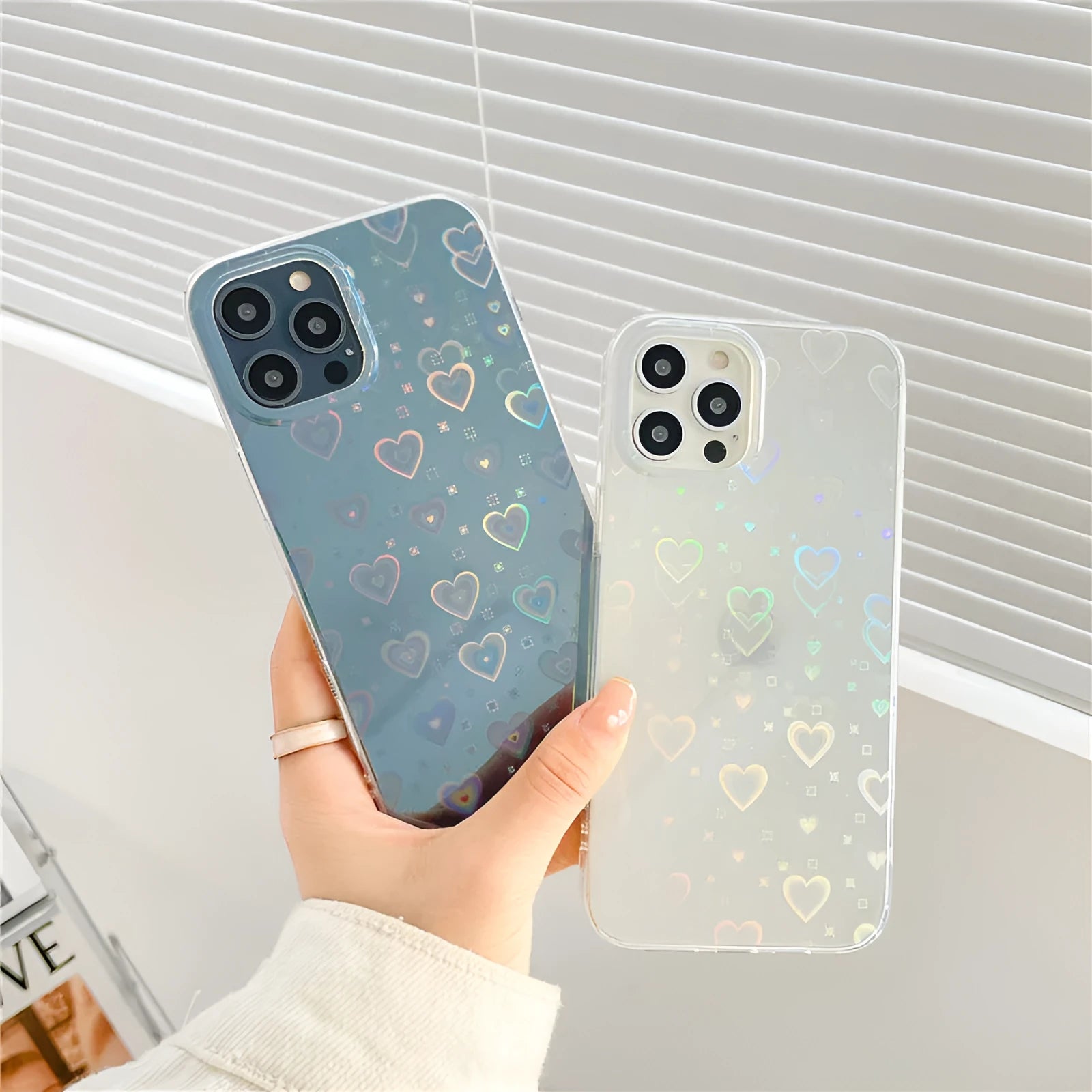 Transparent silicone iPhone case with a laser-etched love pattern, shown fitted on a phone.
