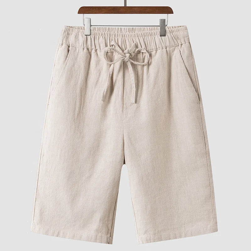 Men's loose-fit linen shorts in a cropped mid-length style with an elastic waistband.
