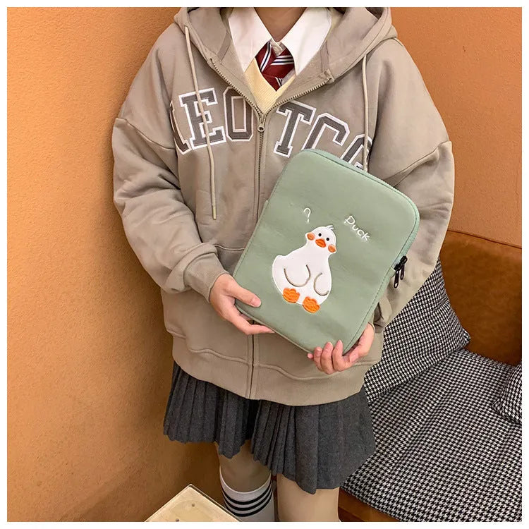 Blue cotton tablet case with embroidered cartoon duck design, zipper closed.