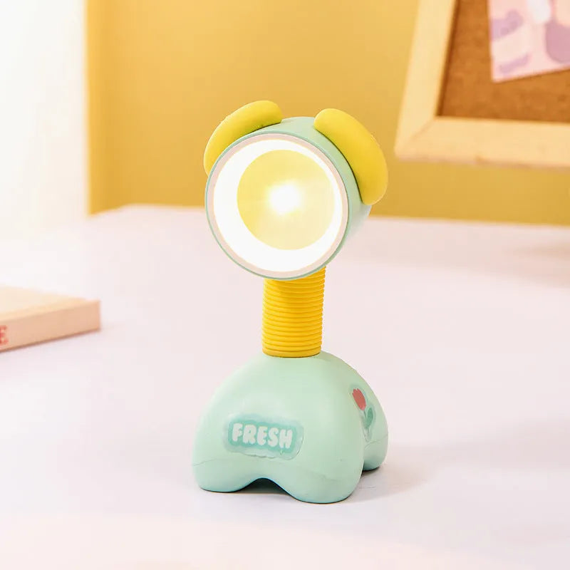 DIY cartoon animal small night lamp with magnetic base in assorted colours on a desk.