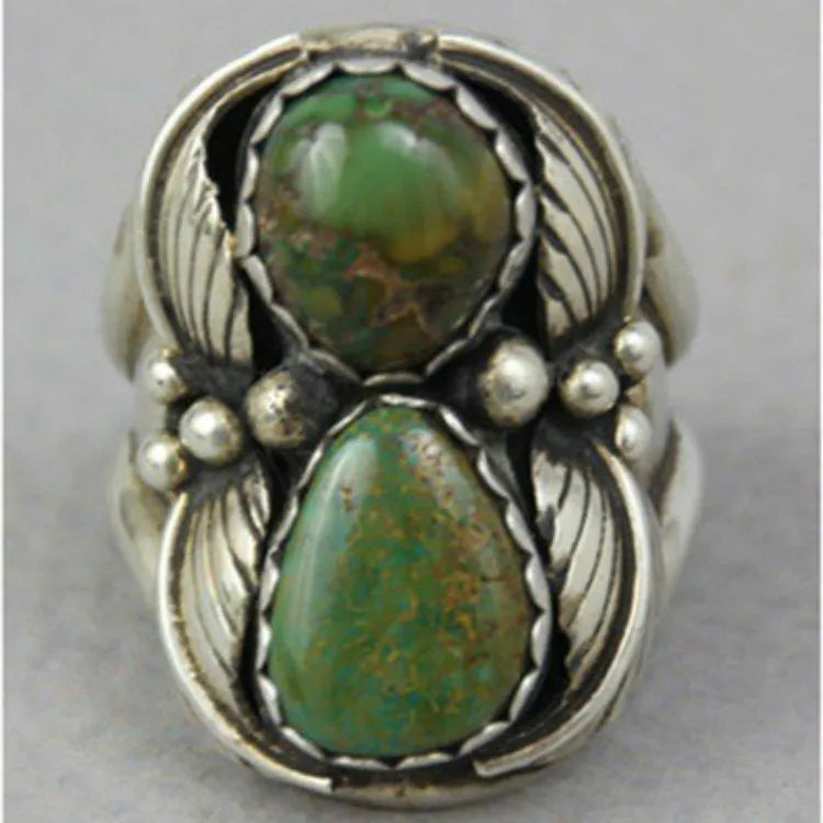 Women's geometric alloy ring with a turquoise inlay on a hand, showing its retro style.