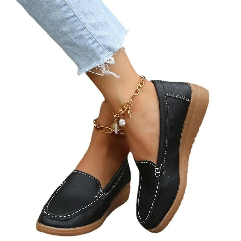 Women's flat slip-on loafers in PU leather with car suture detail, shown in multiple colours.
